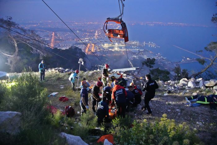 Members of Turkey's Disaster Management Authority (AFAD) take part in a rescue operation after a cable car cabin collided with a broken pole, in Antalya, Turkey.