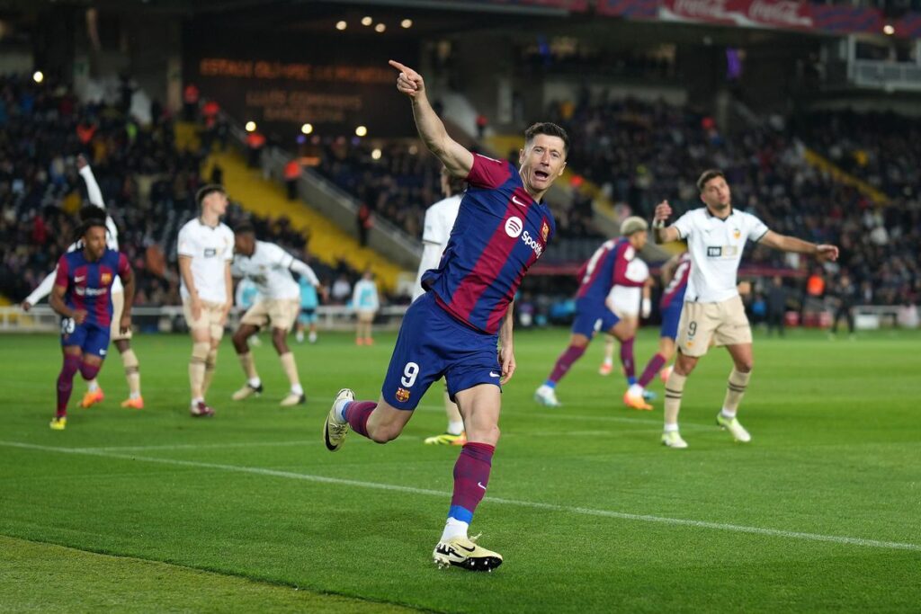 Barcelona striker Robert Lewandowski scored a hat-trick in the second half to help his side fight back to claim a hard-fought 4-2 win on Monday over visitors Valencia, who were leading 2-1 when they were reduced to 10 men just before the break.