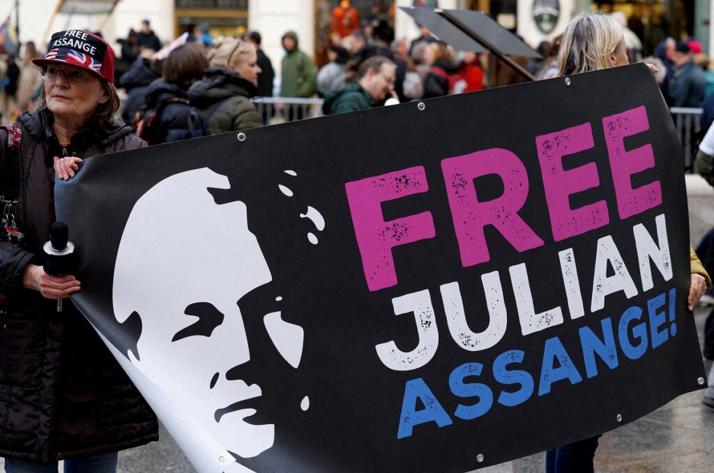 FILE PHOTO: A supporter of WikiLeaks founder Julian Assange holds a sign, on the day the High Court is set to rule on whether Julian Assange can appeal against extradition from Britain to the United States, in London, Britain, March 26, 2024. REUTERS/Toby Melville/File Photo