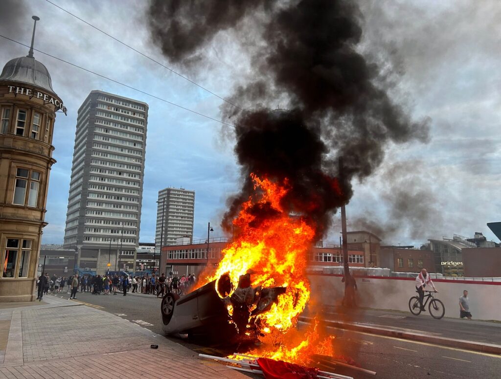 Protesters attacked police and started fires in Sunderland on Friday as violence following Monday's killing of three children in northwest England spread to another northern city.