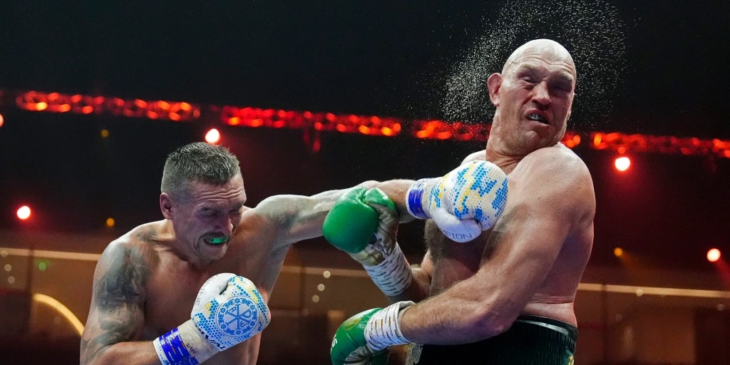 World heavyweight champion Oleksandr Usyk landed the first blow in his re-match with Tyson Fury as he got the British fighter to sign a photograph of him being punched in the face