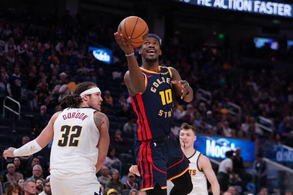 Apr 4, 2025; San Francisco, California, USA; Golden State Warriors forward Jimmy Butler III (10) dribbles to the basket past Denver Nuggets forward Aaron Gordon (32) in the third period at Chase Center. Mandatory Credit: David Gonzales-Imagn Images