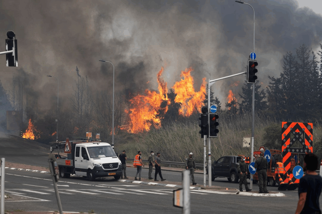 Wildfires raged on the outskirts of Jerusalem, forcing the evacuation of communities as Israel appealed for international assistance.