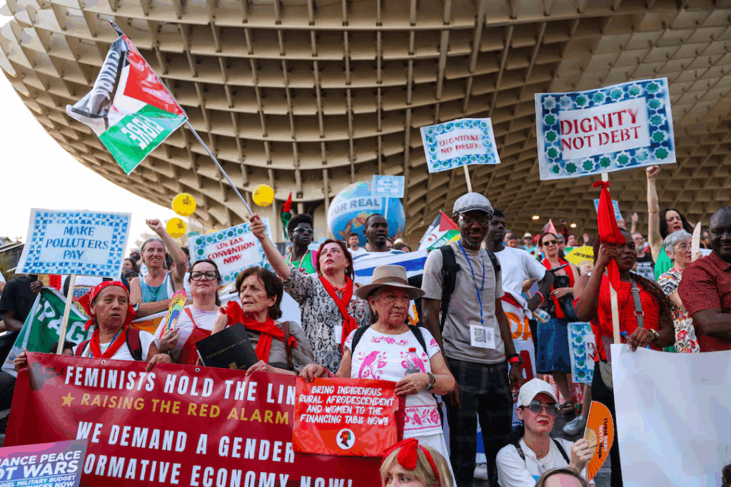 Activists marched in blistering heat through Seville on Sunday, calling for debt cancellation, climate justice and taxing the super rich.