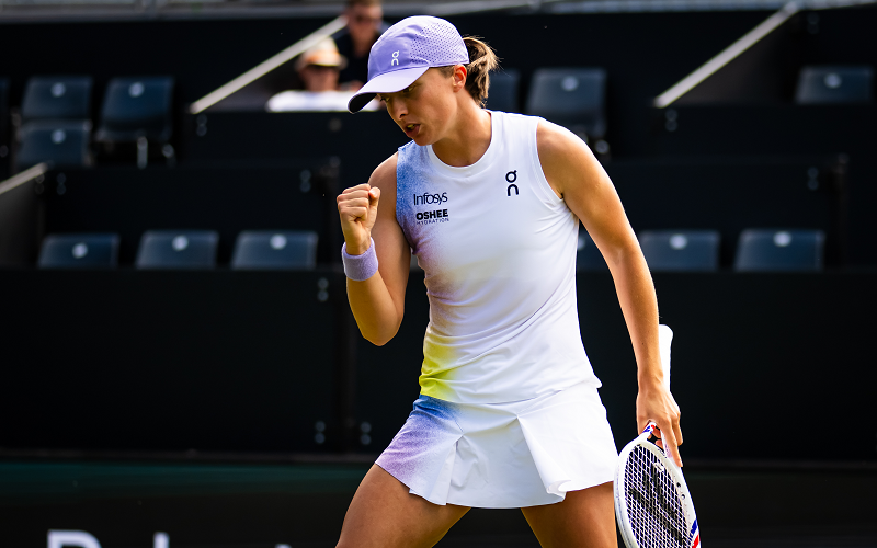 Iga Swiatek solved crossword puzzles during an hour-long rain interruption on Thursday but kept her focus to earn a 6-4 7-6(5) victory.