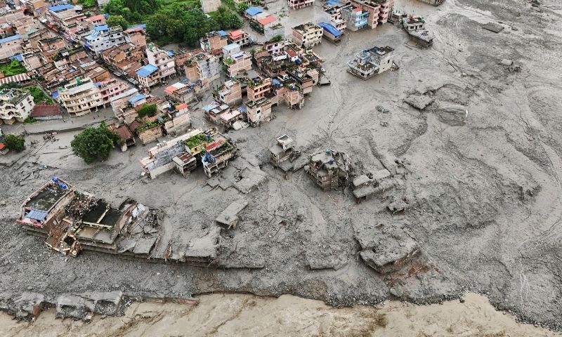 A drone view shows mud covering properties following a flash flood in Trishuli, Nuwakot district, Nepal